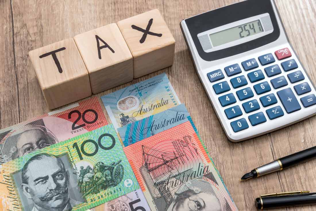 Australian currency, calculator, and tax blocks representing financial planning and investment strategies.