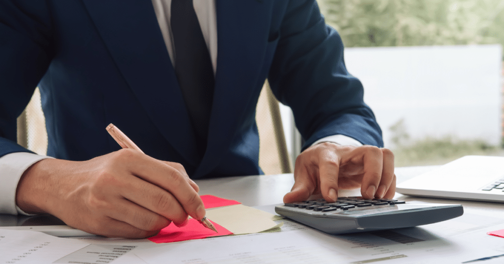 Close up Businessman with pen and paper and calculator