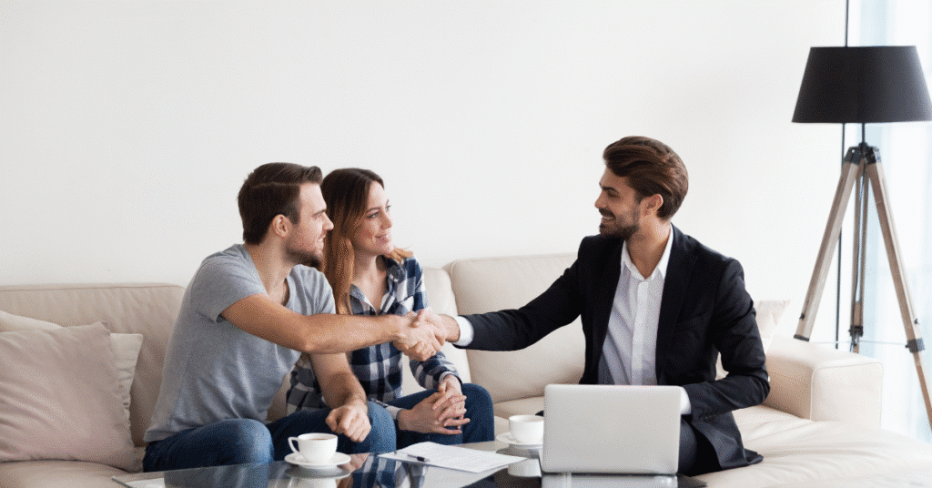 Young couple, family making deal with Property Buyers Agent